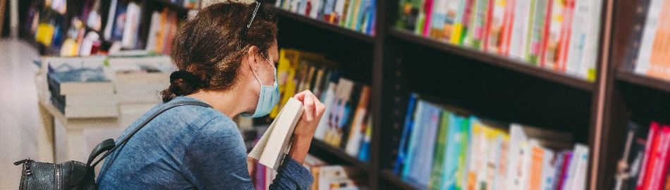 Image female looking at bookshelves